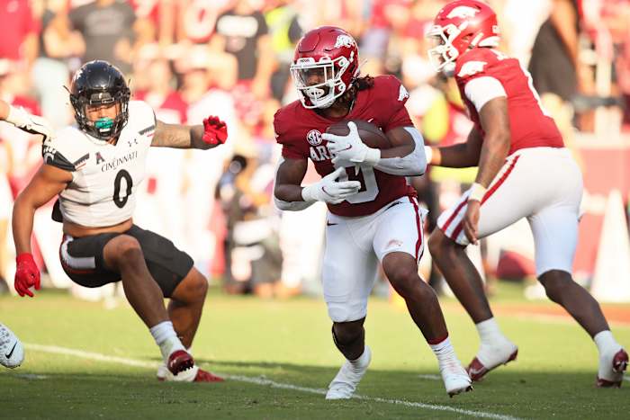 Sep 3, 2022; Fayetteville, Arkansas, USA; Arkansas Razorbacks running back AJ Green (0) runs the ball against Cincinnati Bearcats linebacker Ivan Pace Jr (0) in the fourth quarter at Donald W. Reynolds Razorback Stadium. Arkansas won 31-24. Mandatory Credit: Nelson Chenault-USA TODAY Sports